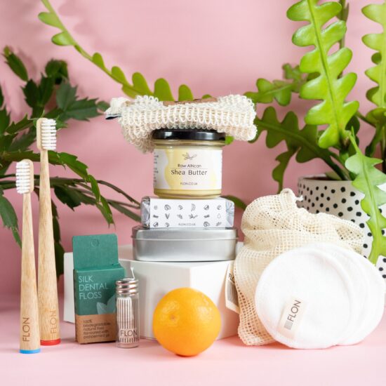 An assortment of Eco-friendly products, including a toothbrush and toothpaste from the Eco Bathroom Gift Set by FLON, perfect as a thoughtful gift or for personal use.